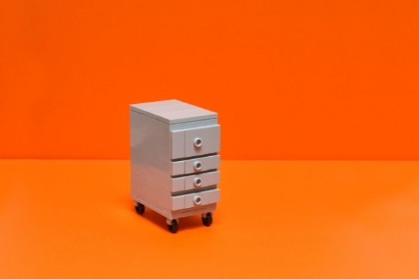 an office file drawer with an orange background